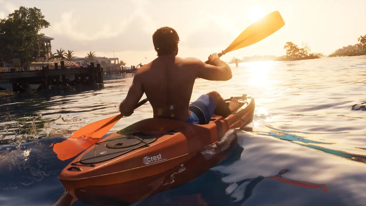 Jason sailing through the water in an orange Crest Kayak, shirtless.