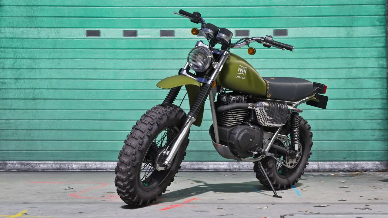 A green Dinka Enduro motorcycle parked outside of a garage.